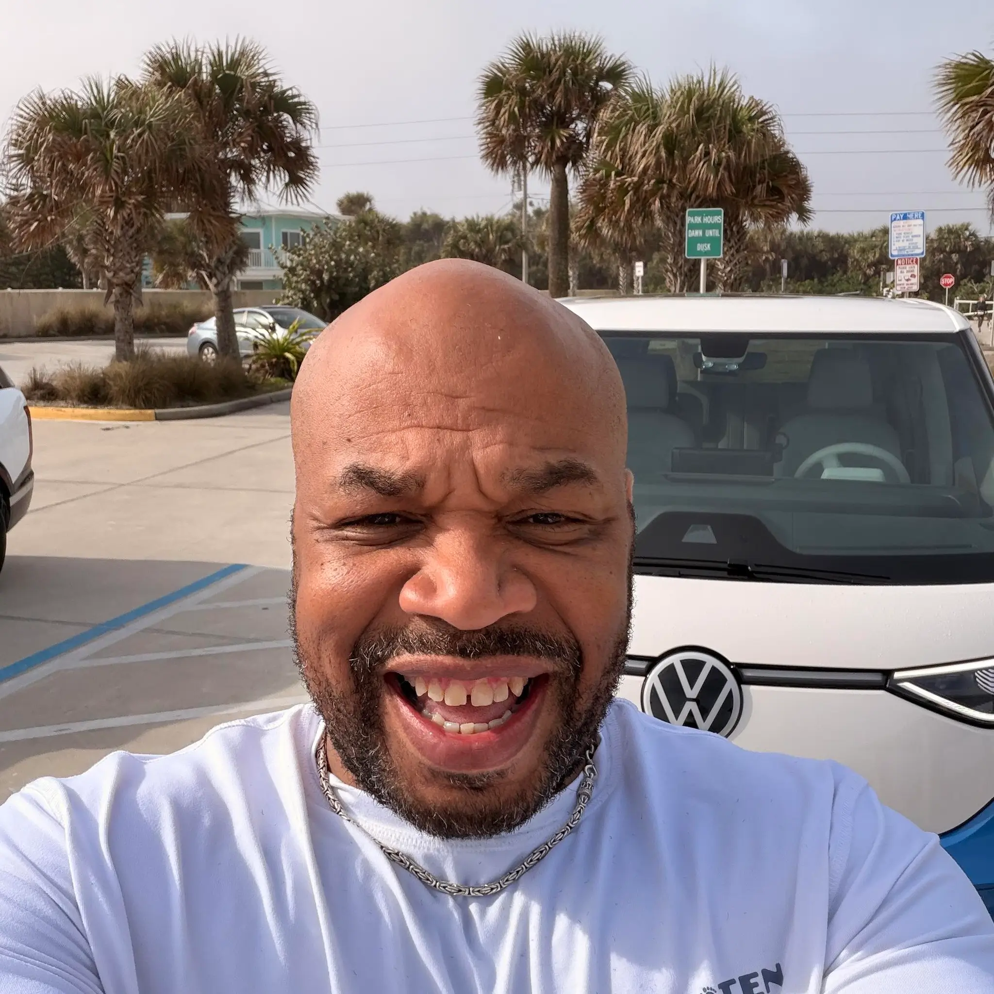 Corey Steward, owner and operator of Irie Transportation, standing with an Irie vehicle