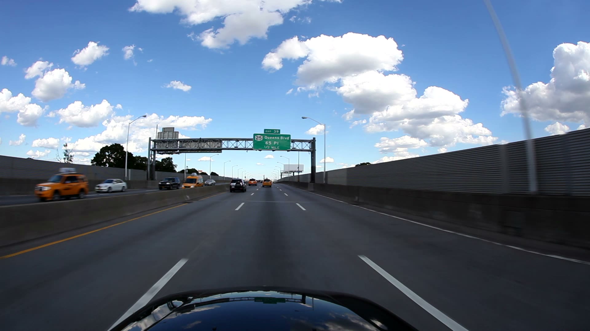 A sunlit highway from the driver’s perspective
